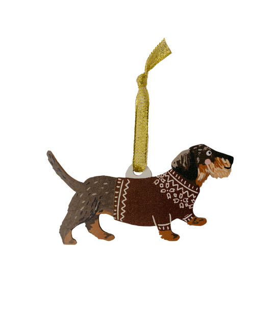 Dog ornament wearing a sweater with a gold tag on a white background