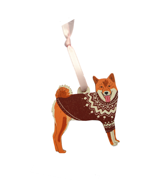 Dog-shaped ornament wearing a sweater with a ribbon on a white background